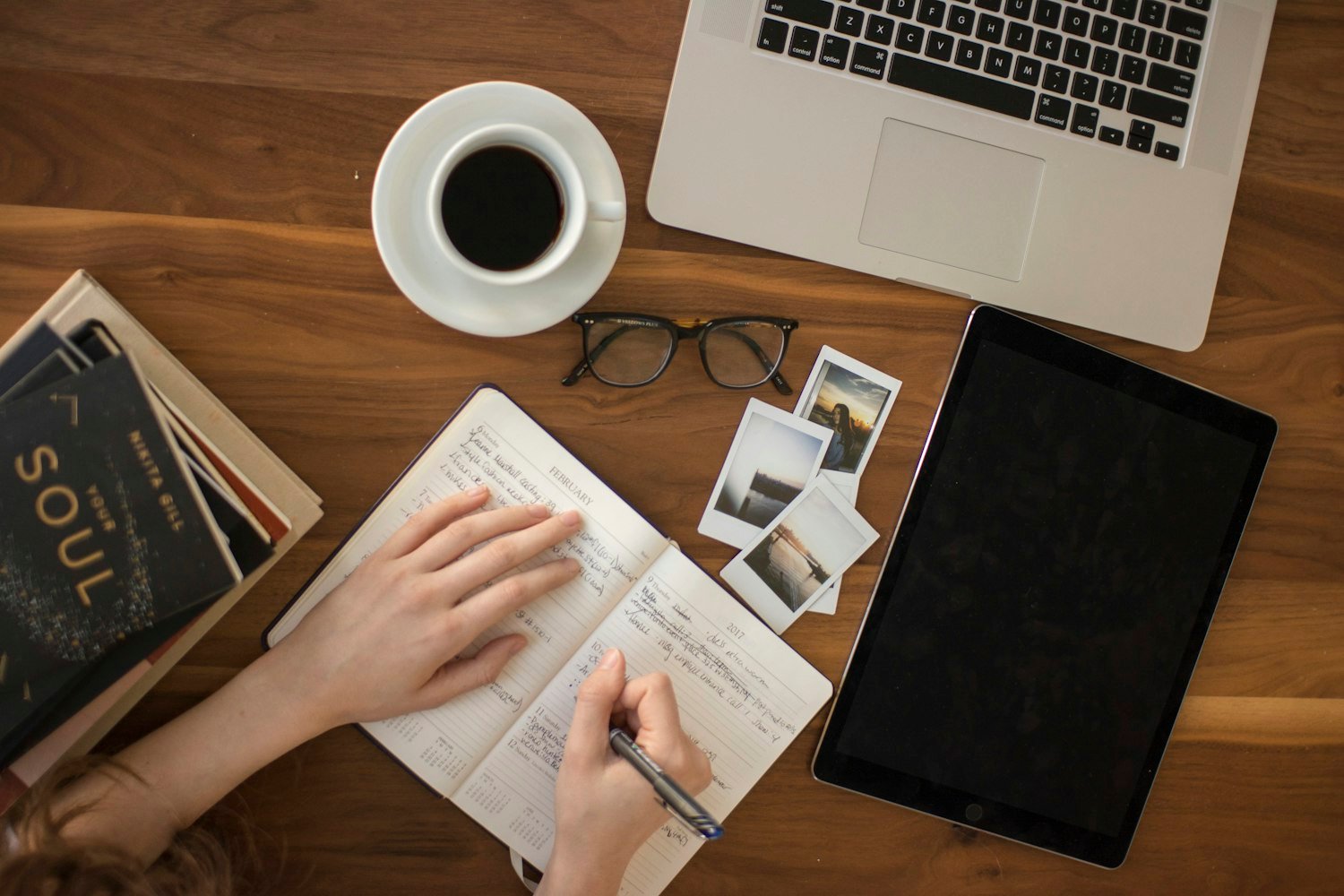A journal, coffee and tablet laid out for a calm morning of reflection